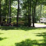 Large motorhome with small trailer nearby
